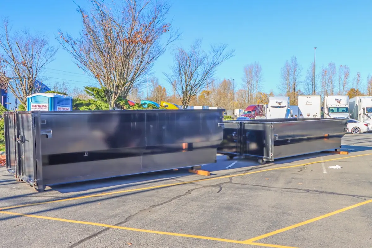 Professional dumpster rental service with roll-off container on residential driveway in Yosemite Lakes